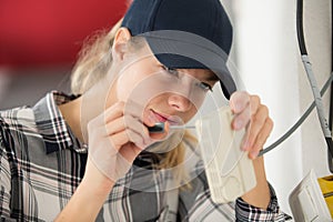 female electrician installing device