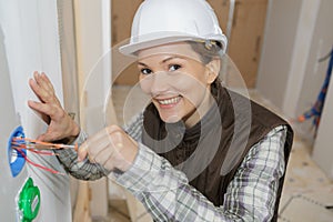 female electrician installing wall socket