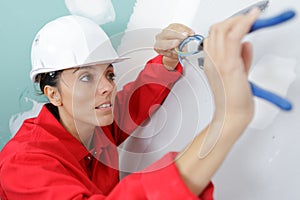 female electrician installing wall socket