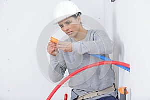 female electrician installing wall socket