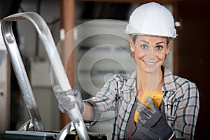 female electrician taking multimeter reading from vintage meter