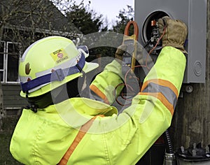 Female electrician using her meter