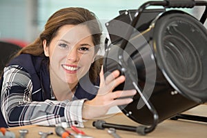 Female electrician working on appliance