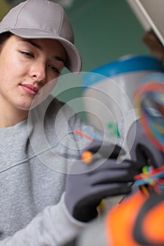 female electrician working on wiring