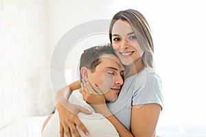 Female Embracing Man With Affection At Home