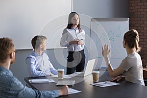 Female employee asking question to business speaker during metin