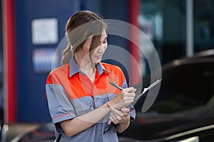 Female employee of customers in car maintenance department. Car center accountant. woman holding clipboard checking maintenance