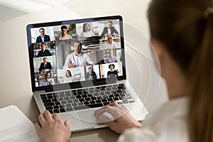 Female employee engaged in webcam conference with diverse colleagues