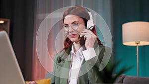 female employee in glasses works remotely as a call center operator communicates with a client using a video call on a