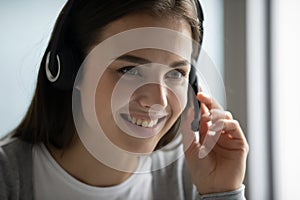 Female employee in headset consult client online