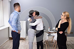 Female Employee Hugging Embracing Happy Coworker photo