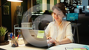 Female employee proofreading a document before transcribing on notebook