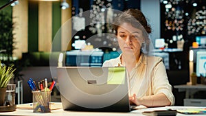 Female employee proofreading a document before transcribing on notebook
