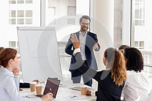 Female employee raise hand answering at work office training