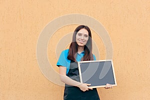 Female Employee Wearing Uniform Apron Holding Blackboard Sign