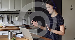 Female employee working from home negotiates with client by videoconference
