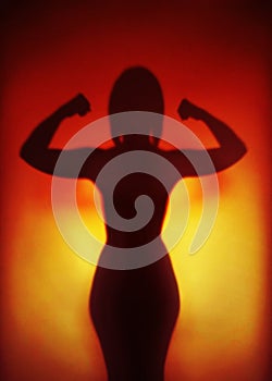 Female empowerment concept silhouette of a strong woman flexing muscles