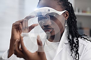 Female Engineer Checking 3D Sample with Magnifying Glasses