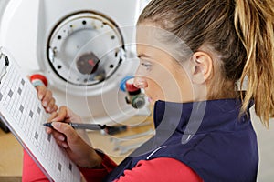 female engineer checking temperature boiler