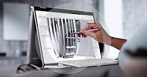 Female Engineer Developing Mechanical Parts Using 3D CAD Software On Laptop