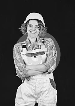Female engineer in hardhat. woman architect in checkered shirt inspecting construction. Building project management and
