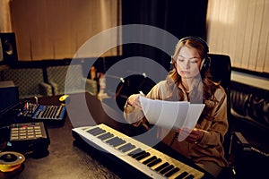 Female engineer in headphones, recording studio