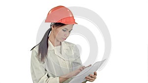 Female engineer in helmet reading contract and nodding her head on white background