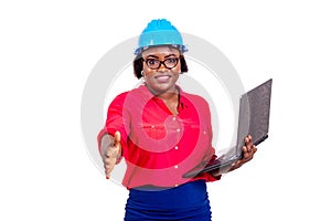 Female engineer holding laptop computer and offering handshake smiling