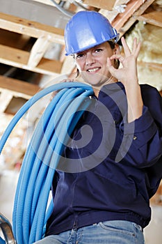 Female engineer holding pipes