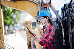 A female engineer is inspecting work at the construction site