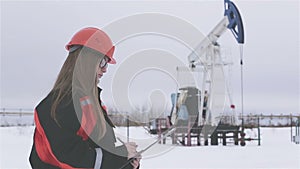 Female engineer and oil man working together in an