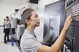 Female Engineer Operating CNC Machinery In Factory