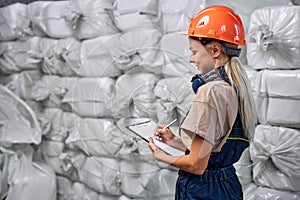 female engineer in protective workwear working in pesticides production factory