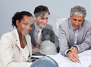 Female engineer studying plans in a metting