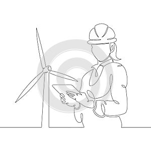 Female engineer with a tablet in a helmet against the background of a wind power station, clean renewable energy