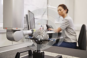 Female Engineer Uses CMM Coordinate Measuring Machine In Factory photo