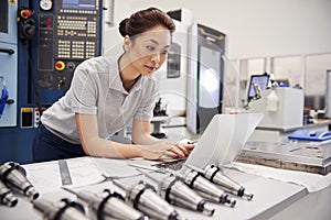 Female Engineer Using CAD Programming Software On Laptop