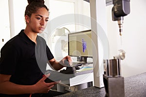 Female Engineer Using CAD System To Work On Component photo