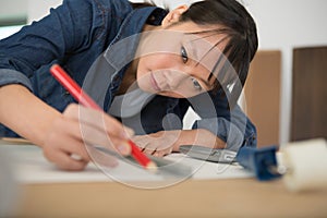 female engineer using pencil drawing