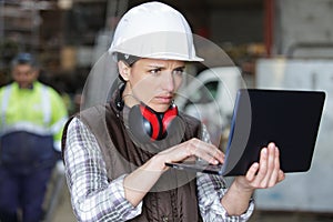 Female engineer using programming software on laptop