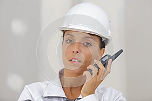 female engineer using walkie-talkie indoors