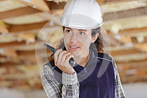 female engineer using walkie-talkie indoors