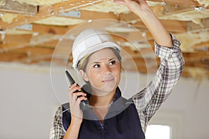 Female engineer using walkie-talkie in shipping yard photo