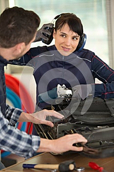 female engineer working on factor lifting protective ear muffs