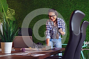 Female engineer working in her office with a cup of coffee in hands