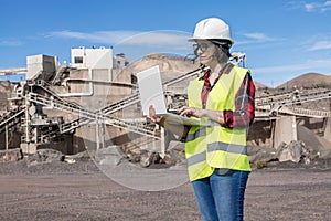 Female engineer working with laptop on construction site photo