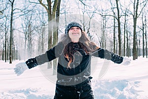 Female enjoying the snow in winter park