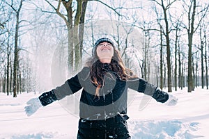 Female enjoying the snow in winter park