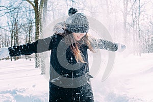 Female enjoying the snow in winter park