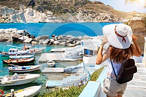 Female enjoys the view to the fishing village of Mandrakia on the island of Milos, Cyclades